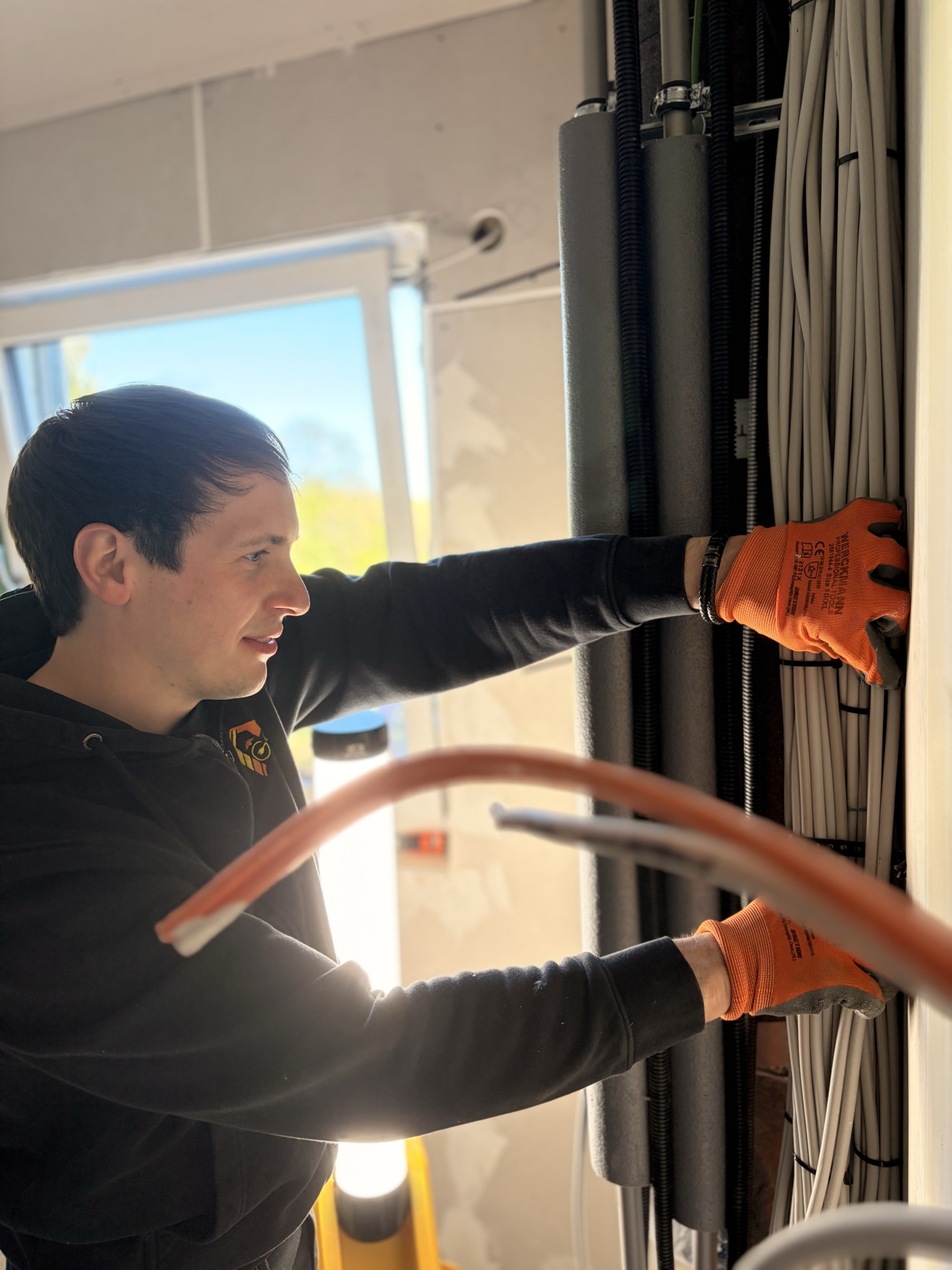 Elektriker verlegt Kabel auf der Baustelle